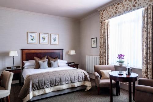 贝辛斯托克Audleys Wood Hotel, Basingstoke的一间卧室设有一张床和一个大窗户