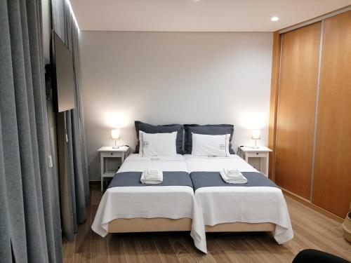 丰沙尔Apartments Madeira Funchal City的一间卧室设有一张大床和两个床头柜