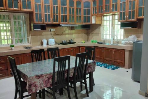 哥打巴鲁3R3B in Kota Bharu near Datu River的一个带桌椅的大厨房