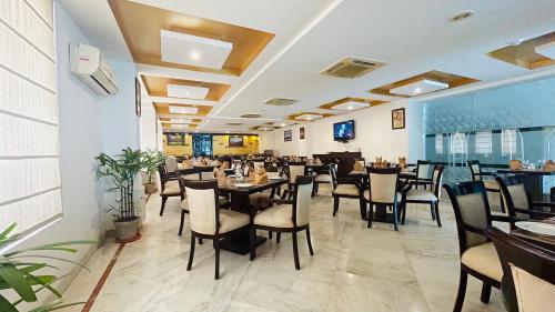 阿格拉Surasena Regal Vista Agra的餐厅内带桌椅的用餐室