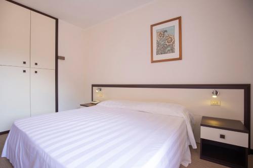 费拉约港发布易斯雅酒店的卧室配有白色的床和黑色床头柜