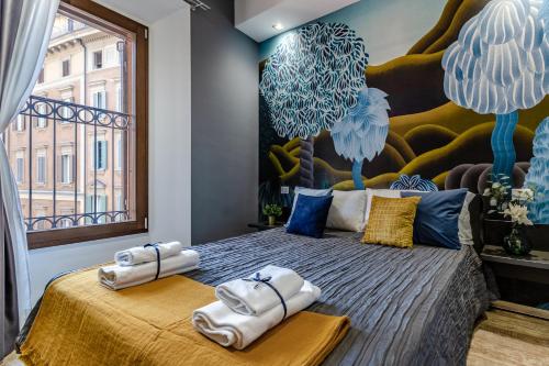 博洛尼亚Ugo Bassi Apartments的一间卧室配有一张大床和毛巾