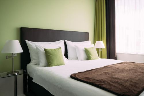 图恩楚真施特菲斯堡酒店的一间卧室配有一张带绿色窗帘的大床