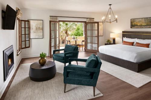 Kenwood肯伍德酒店&Spa中心的一间卧室设有一张床,客厅设有壁炉。