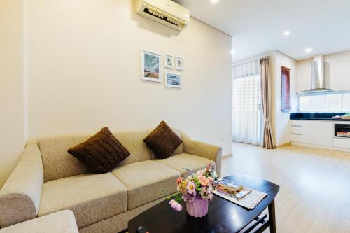 河内HB Serviced Apartment - 12 Trần Quý Kiên的客厅配有沙发和桌子