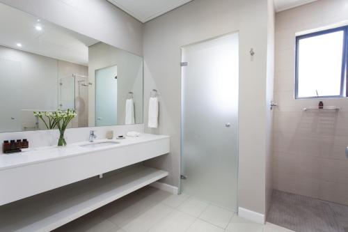弗朗斯胡克Pearl Valley Hotel by Mantis的白色的浴室设有水槽和淋浴。