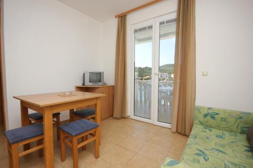 萨利Apartments and rooms by the sea Zaglav, Dugi otok - 8144的客厅配有桌椅和电视。