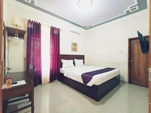 Hotel Manggala Syariah客房内的一张或多张床位