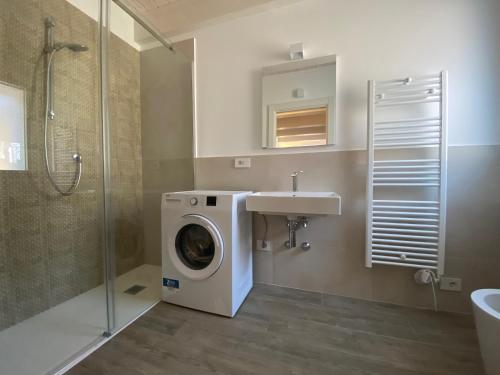 雷卡纳蒂港Appartamenti nuovi in centro a Porto Recanati Riviera del Conero的一间带洗衣机和水槽的浴室