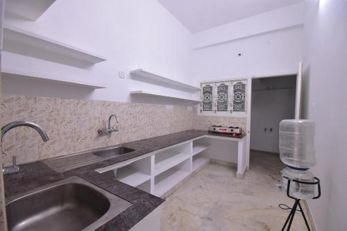 蓬蒂切里BHARATHI RESIDHOME的厨房配有水槽和台面