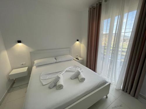 卡萨米尔Villa Denis Ksamil的卧室配有白色床和毛巾