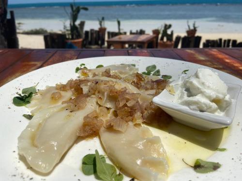 Haad Son秘密海滩别墅度假屋的海滩附近的餐桌上放着一盘食物