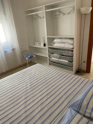 索威拉托玛里纳Corso Umberto Apartment的一间卧室配有一张床和一张蓝色椅子