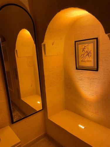 MidyatKasri Mezopotamya的浴室里一面镜子,一面有架子和照片