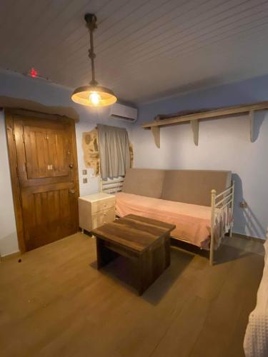 VolissosΠεριβόλι του Οδυσσέα的一间卧室配有一张床和一张桌子