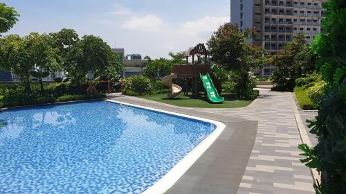 马尼拉Heart of Makati, Fully furnished condo, cbd central location的一个带滑梯的游泳池和一个游乐场