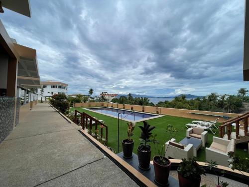 波尔多·格尼拉佛得角景别墅酒店的阳台享有游泳池和植物的景致。