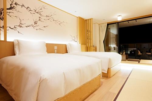 大石Kumonoue Fuji Hotel - Vacation STAY 13700v的配有电视的酒店客房内的两张床