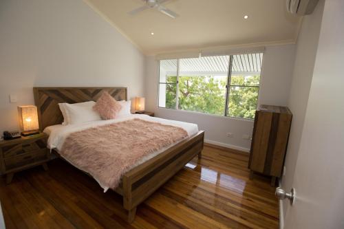 莫尔兹比港港威酒店的一间卧室设有一张大床和一个窗户。