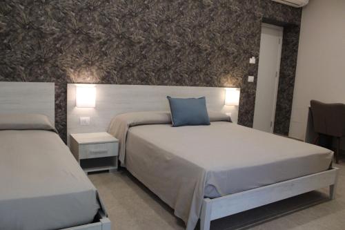 普拉亚·阿马勒Albadorata的一间卧室配有两张床和壁画