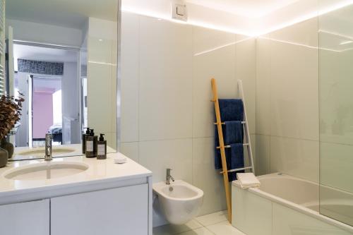 波尔图Porto Insight Apartment River View - Pool & Garage的浴室配有盥洗盆、卫生间和浴缸。