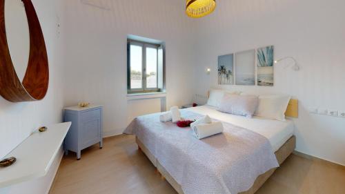 克里希阿克提ONAR RESIDENCE PAROS的白色卧室设有床铺和水槽