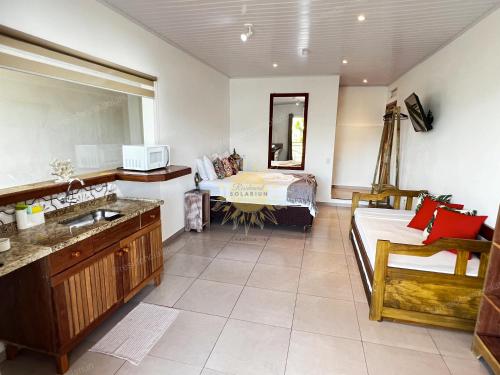 伊利亚贝拉Residencial Solariun Ilhabela的一间带水槽的浴室和一张位于客房内的床