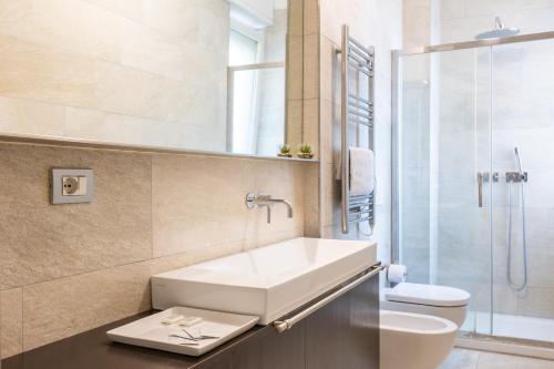 米兰Rosselli 13 Milan Apartment的一间带水槽、卫生间和淋浴的浴室