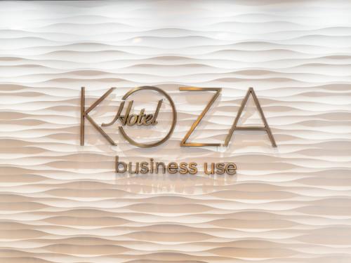 冲绳岛市科扎酒店的海浪背景上的酒店或商业用途标志