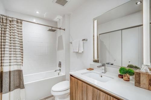 迈阿密Sentral Wynwood的浴室配有盥洗盆、卫生间和浴缸。