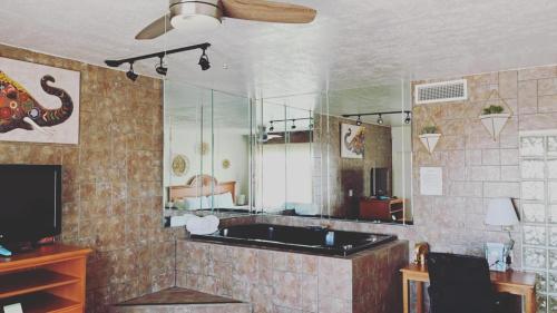 阿拉莫戈多The Classic Desert Aire Hotel的一间带浴缸和大镜子的浴室