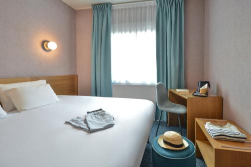 博讷Sure Hotel by Best Western Centre Beaune的配有一张床、一张书桌和一扇窗户的酒店客房