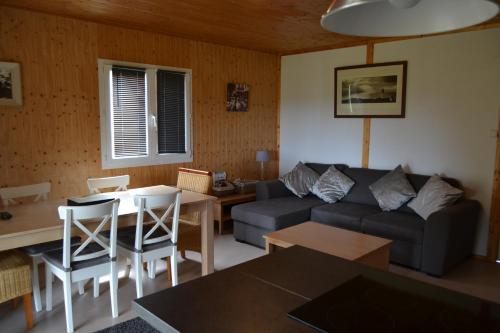 Saint-Manvieu-BocageBeautiful lake view 3 bedroom chalet.的客厅配有沙发和桌子