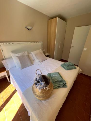 卡兰博希Bonito apartamento con terraza, jardín y piscina的一间卧室,配有一张带篮子的床