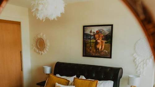 格拉斯哥Lovely Bohemian Apartment in Heart of City Life的卧室配有壁画和沙发