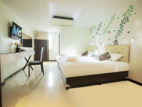 MD Grand Hotel Nakhon客房内的一张或多张床位
