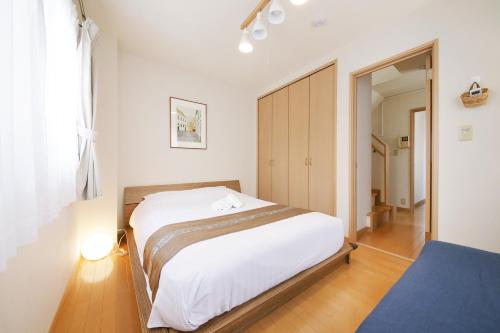 东京押上ハウス的卧室配有一张白色大床和镜子