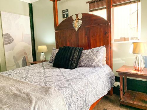 格拉斯科普哈瓦那之夜度假屋的一间卧室配有一张大床和木制床头板