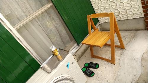 泉佐野MINPAKU-P 民泊p的洗衣机旁的木椅