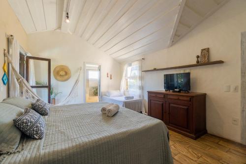 布希奥斯Morada do Sol Guest House的一间卧室配有一张床和一台电视。