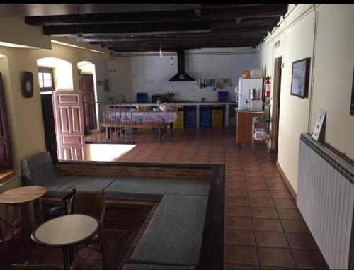 阿斯托加Albergue San Javier - Solo para peregrinos的厨房以及带桌子的客厅。