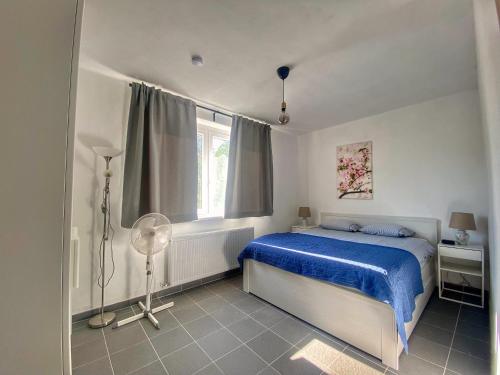 ÁroktőRiver House - Luxury house on the border of the Tisza River的一间卧室设有蓝色的床和窗户。