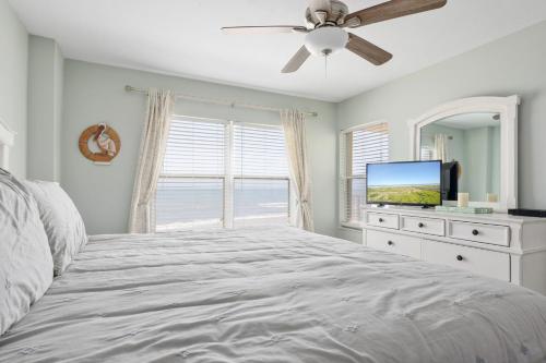 奥蒙德海滩Sea Winds 501 - Corner Breeze的一间卧室配有一张床和一台平面电视