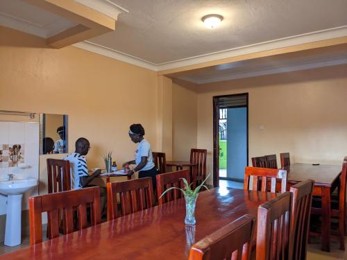 波特尔堡Kasenene Legacy Hotel的两人坐在餐厅桌子旁