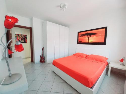 尼阿博勒皮耶韦Tuscany To Love - Holiday Home - Casa Vacanze的一间卧室配有一张红色床罩的床