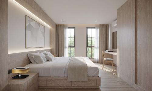 曼谷Leon Lasalle Hotel and Residences的卧室配有一张床、一张书桌和窗户。