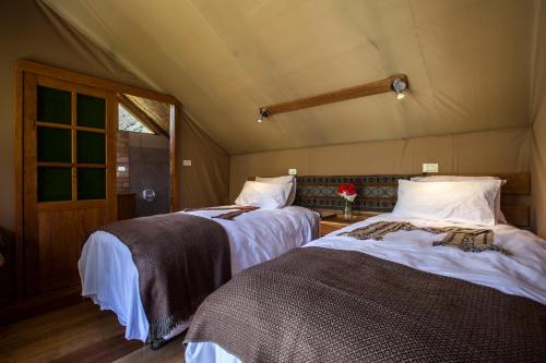 库斯科Inca Trail Glamping的一间帐篷内带两张床的卧室