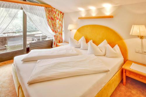 加舒恩普法伊费尔酒店的一间卧室设有两张床和大窗户