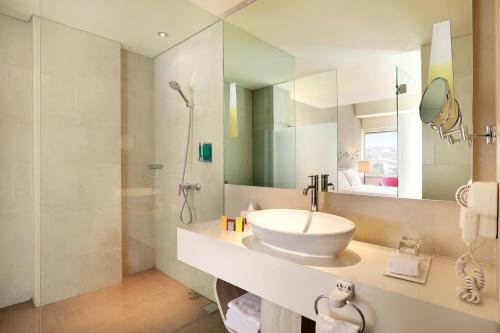 雅加达雅加达卡查玛达宜必思尚品酒店的白色的浴室设有水槽和淋浴。