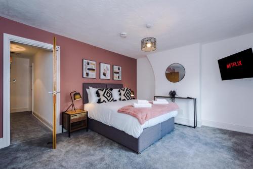 切斯特Faulkner House的一间卧室配有一张粉红色墙壁的床